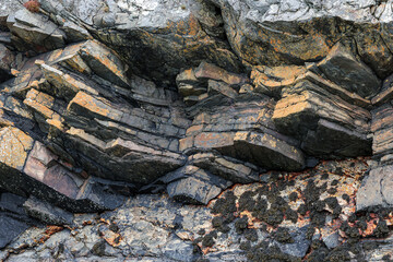 Layered coastal rock formation close up