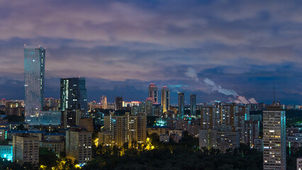 Fototapeta premium Panoramic view of Moscow timelapse. Panorama of a big city at night. Residential buildings on Mosfilmovskaya street