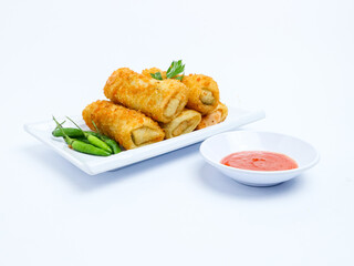 Indonesian crispy rissoles , served on a white plate with spicy red chili sauce and green chili on a white background. Perfect photo of a traditional snack.