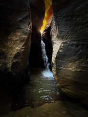 waterfall inside the hiking trail for The Subway slot canyon in Zion National Park, USA