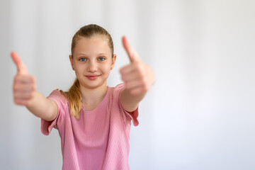 Confident Girl Showing Double Thumbs Up. A smiling young girl gives two thumbs up with extended arms, expressing approval, confidence, or positive feedback in a bright setting. Space for text.