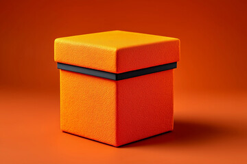 Fototapeta premium Product box displayed on a matte orange backdrop showcasing vibrant color and texture for design inspiration and advertising purposes