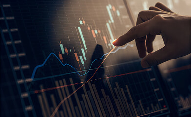 Hand Analyzing Stock Market Data on Screen
