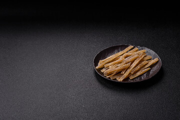 Food, snacks or jerky made from dried dehydrated salted fish with spices. Snacks fish