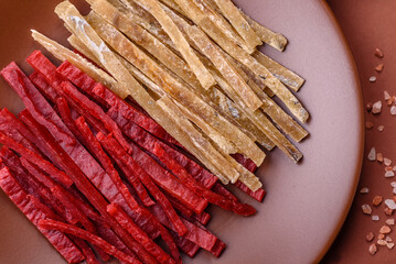 A set of jerky or snacks of chicken and fish with salt and spices