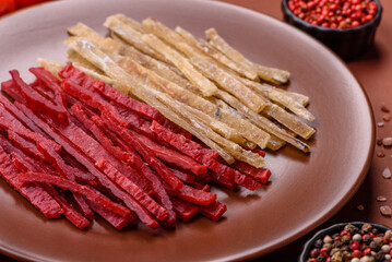 A set of jerky or snacks of chicken and fish with salt and spices