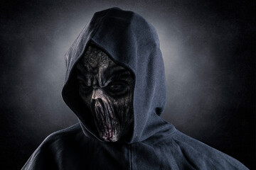 Portrait of a creepy monster over dark misty background