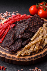 A set of jerky or snacks of beef, chicken and fish with salt and spices