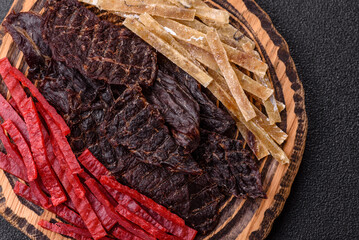 A set of jerky or snacks of beef, chicken and fish with salt and spices