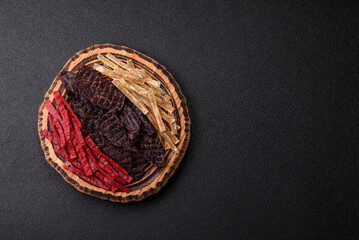 A set of jerky or snacks of beef, chicken and fish with salt and spices