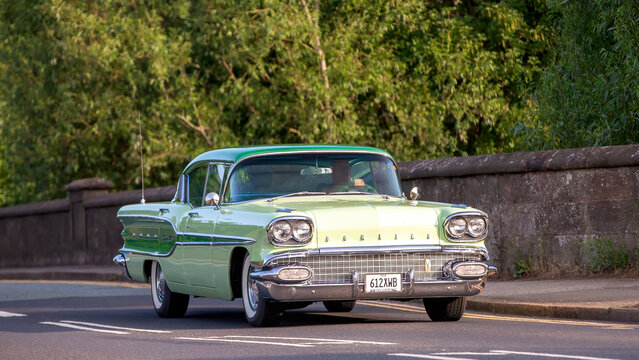 Milton Keynes,Bucks,UK - June 1st 2025:  1958 Pontiac classic American car  driving on a British road.