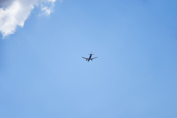 Passenger Plane Taking Off Against Blue Sky and Clouds
