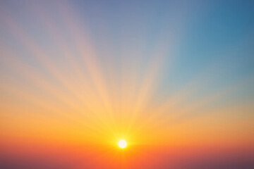 Radiant sunrise with sun rays over clear sky