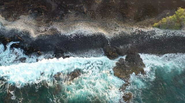 tracking over lava rocks and waves in Maui hawaii