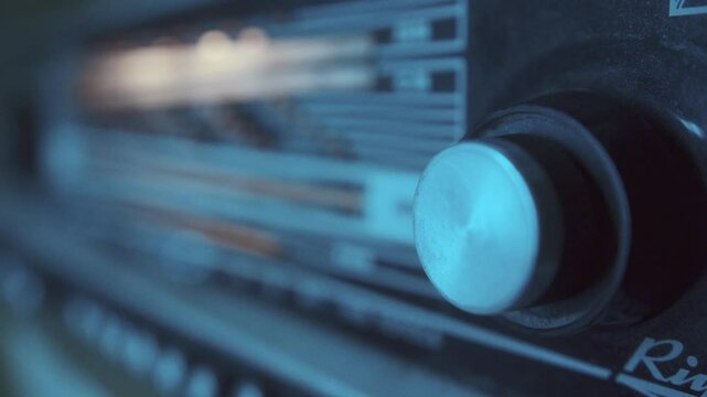 Close Up Of A Hand Tuning An Old Radio Dial Searching For A Station
