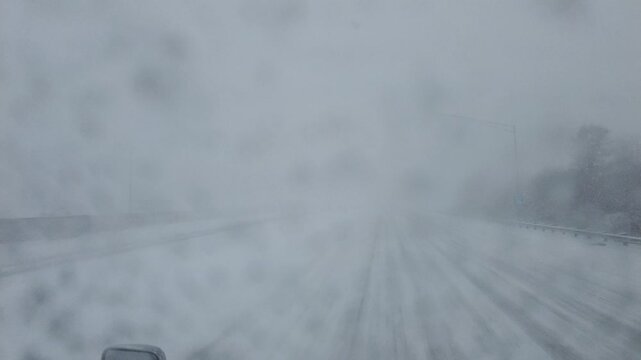 A strong winter storm blankets I-80 in Ohio with thick snow and fog, leaving drivers struggling to stay on the slick highway as visibility drops and traffic grinds to a crawl in icy conditions.