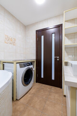 Modern Home Bathroom Interior with Washing Machine and Elegant Countertop Sink