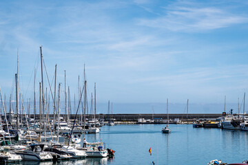Fototapeta premium renys de Mar, Spain-June 03, 2025. Sailboats docking at port of arenys de mar under blue sky