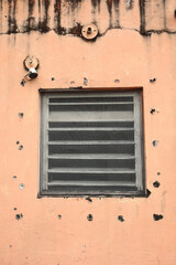 old wooden window in an orange wall