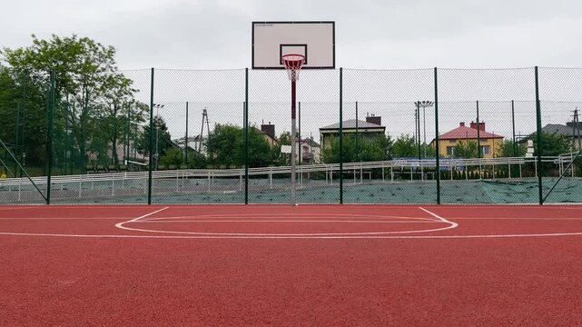 Man player dribbles basketball from one side to other side of basketball court