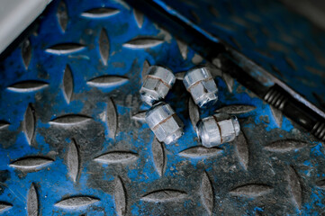 Wheel nuts that have been used with an impact wrench many times.Silver plated steel wheel nuts.