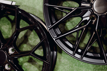 Two different designs of black aluminum wheels.Light wheels made of aluminum.
