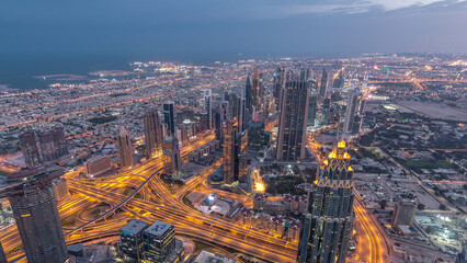 Obraz premium Downtown of Dubai night timelapse before sunrise. Aerial view with towers and skyscrapers
