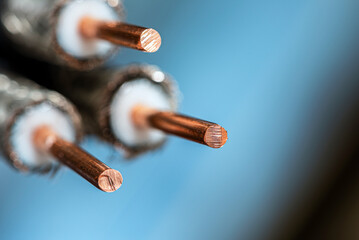 Coaxial cable with exposed shielding and central conductor, on a dark background, close-up view