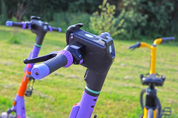 Handlebars and front panel of an electric scooter. Close-up. Soft focus.  