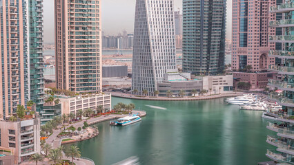 Fototapeta premium Waterfront promenade in Dubai Marina aerial timelapse. Dubai, United Arab Emirates