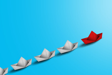 Obraz premium Leadership Concept with Paper Boats. Set of colorful origami ships on blue background. Business competition, Leadership concept with yellow paper ship leading among white.