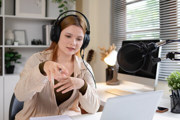 Female podcast host gestures to speech