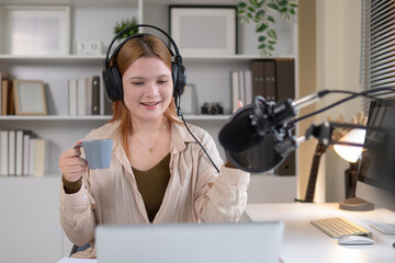 A female podcaster is recording in a quiet studio.