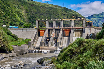 Hydroelectric power station in Ecuador showcasing powerful water flow and lush green landscape with dramatic mountain backdrop
