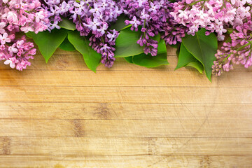 lilac flower arrangement on old board background with free space