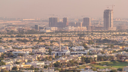 Fototapeta premium Aerial view to villas and houses near Golf course with lakes timelapse.