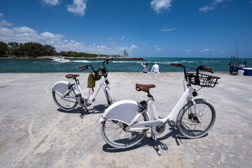 Fototapeta premium two white bicycles on the beach