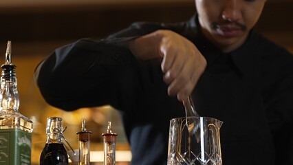 Closeup hand bartender holding jigger to measure liquor sugar into mixing glass ingredients alcohol preparation creative mixed cocktail. Special refresh drink showcasing nightlife mixology. Vinosity.