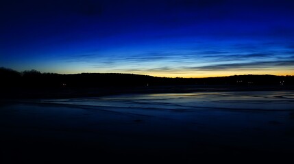 Fototapeta premium Winter sky reflects on frozen landscape