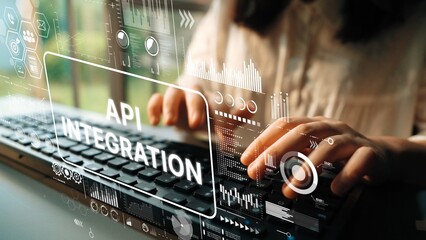 Hands typing on keyboard with digital graphics showing data and API integration concept in modern...