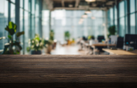 Modern workspace with wooden table showcasing greenery and open office layout in bright natural light