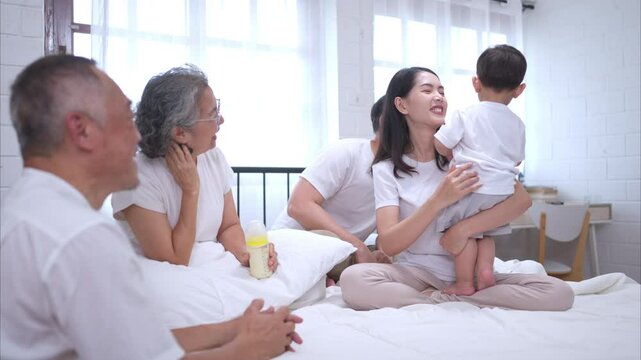 Before putting the kids to bed, parents, grandparents, and kid unwind and play in the bedroom