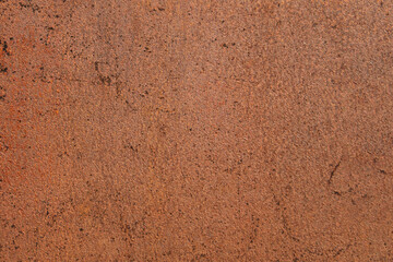 Abstract rusty metal surface with rough texture and brown orange tones creates a grunge industrial background for design or creative projects.