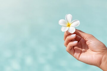 Delicate Hand Holding White Tropical Flower by Water
