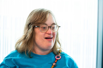 Portrait of a 42 yo woman with the Down Syndrome smiling in Tienen, Flemish Brabant Region, Belgium
