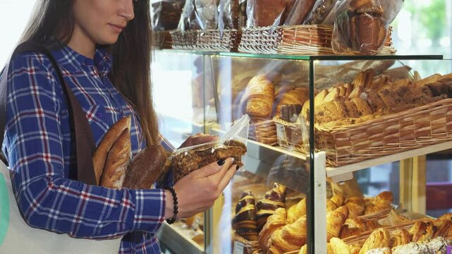 Female customer exploring delicious cookie options at the bakery