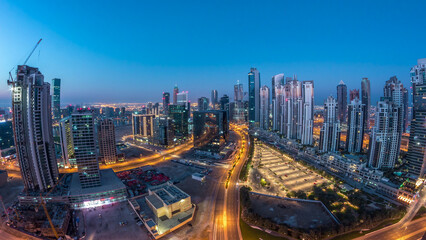 Obraz premium Panorama of Business bay Dubai night to day aerial timelapse.