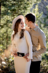A Couple Joyfully Celebrating Their Pregnancy Announcement Surrounded by Beautiful Nature