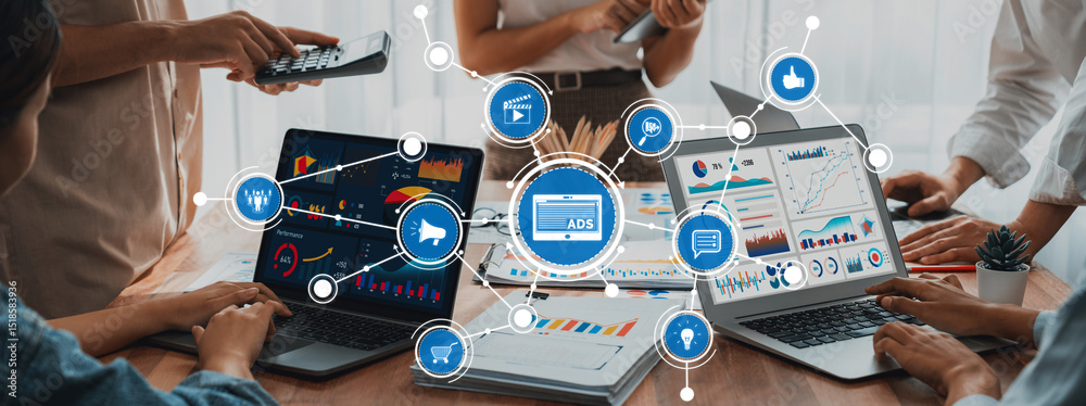 Fototapete A dynamic team collaborates in a modern workspace, analyzing digital marketing data on laptops. The scene captures the essence of teamwork, innovation, and data-driven strategies. Amity