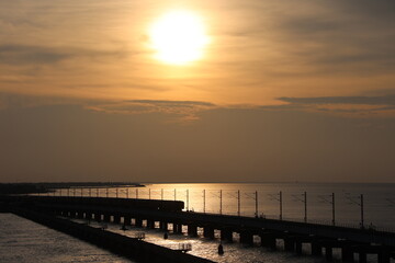 Obraz premium The Pamban bridge train crossing at evening, sunset on the sea, sea bridge connecting pamban and rameshwaram island to mainland, transportation, Ramanathapuram, Tamilnadu, India,asia 